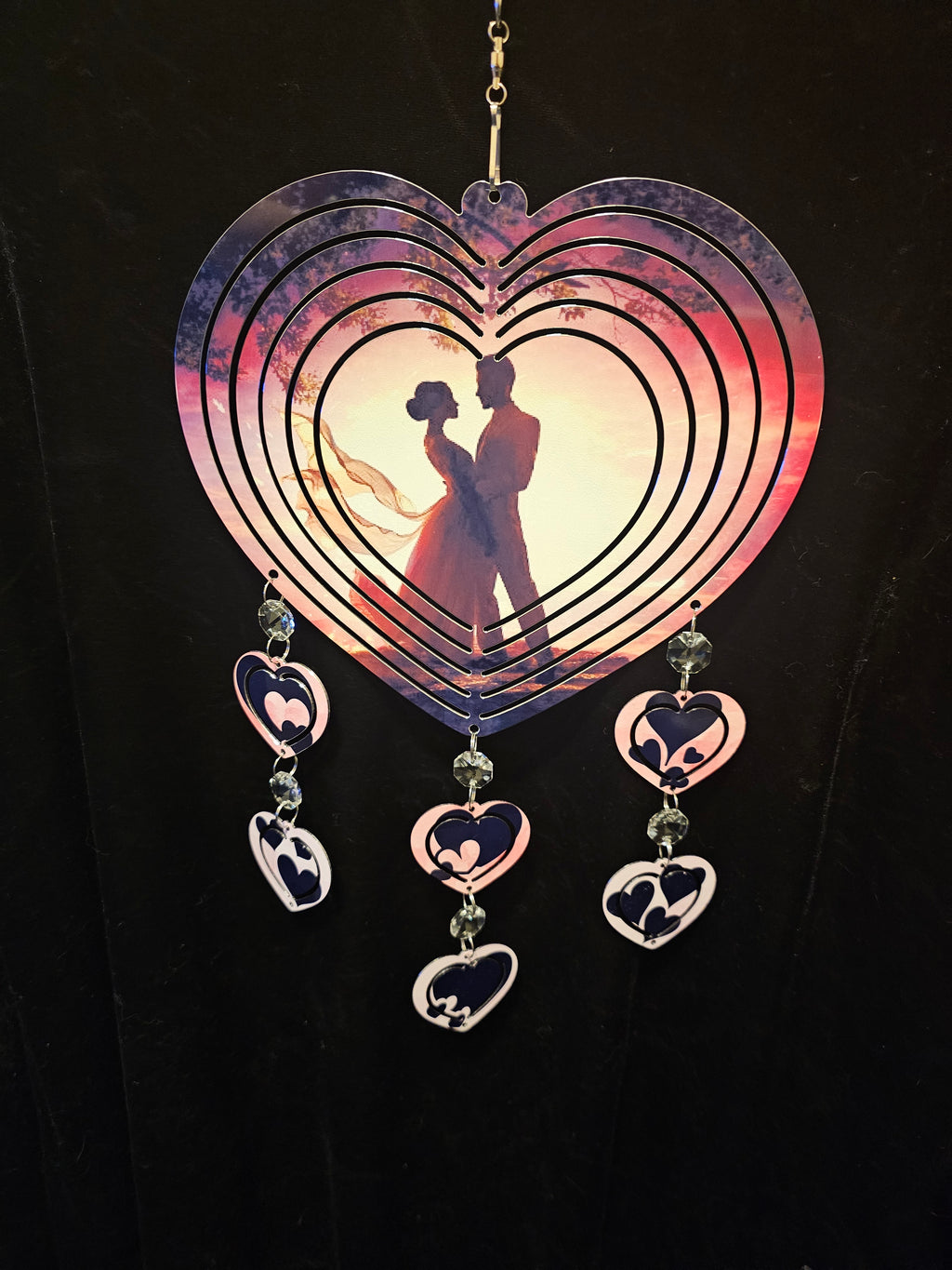 Heart Shaped Wind Spinner with a Loving Couple in the Sunset