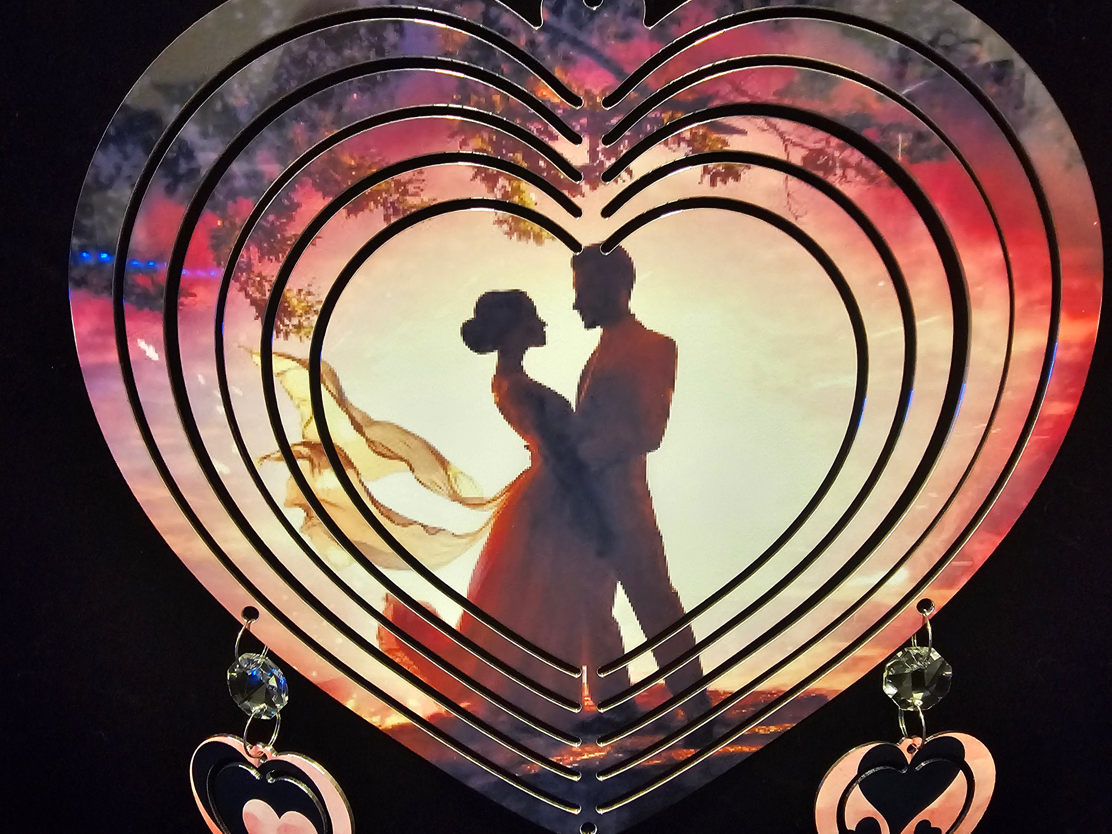 Heart Shaped Wind Spinner with a Loving Couple in the Sunset