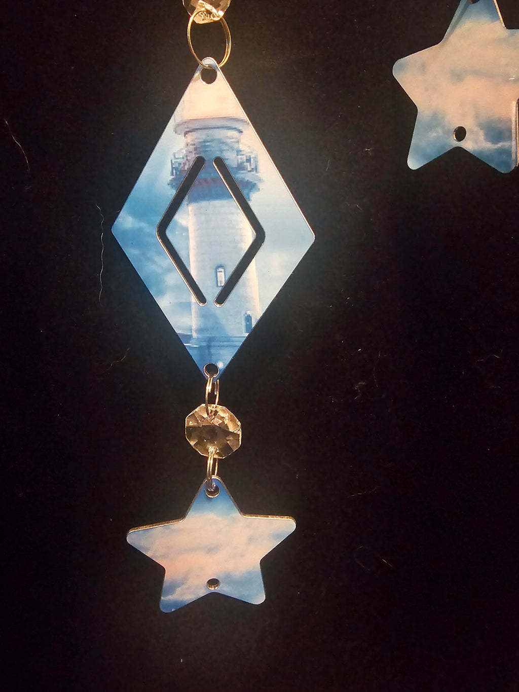 Moon Shaped Wind Spinner with a Lighthouse