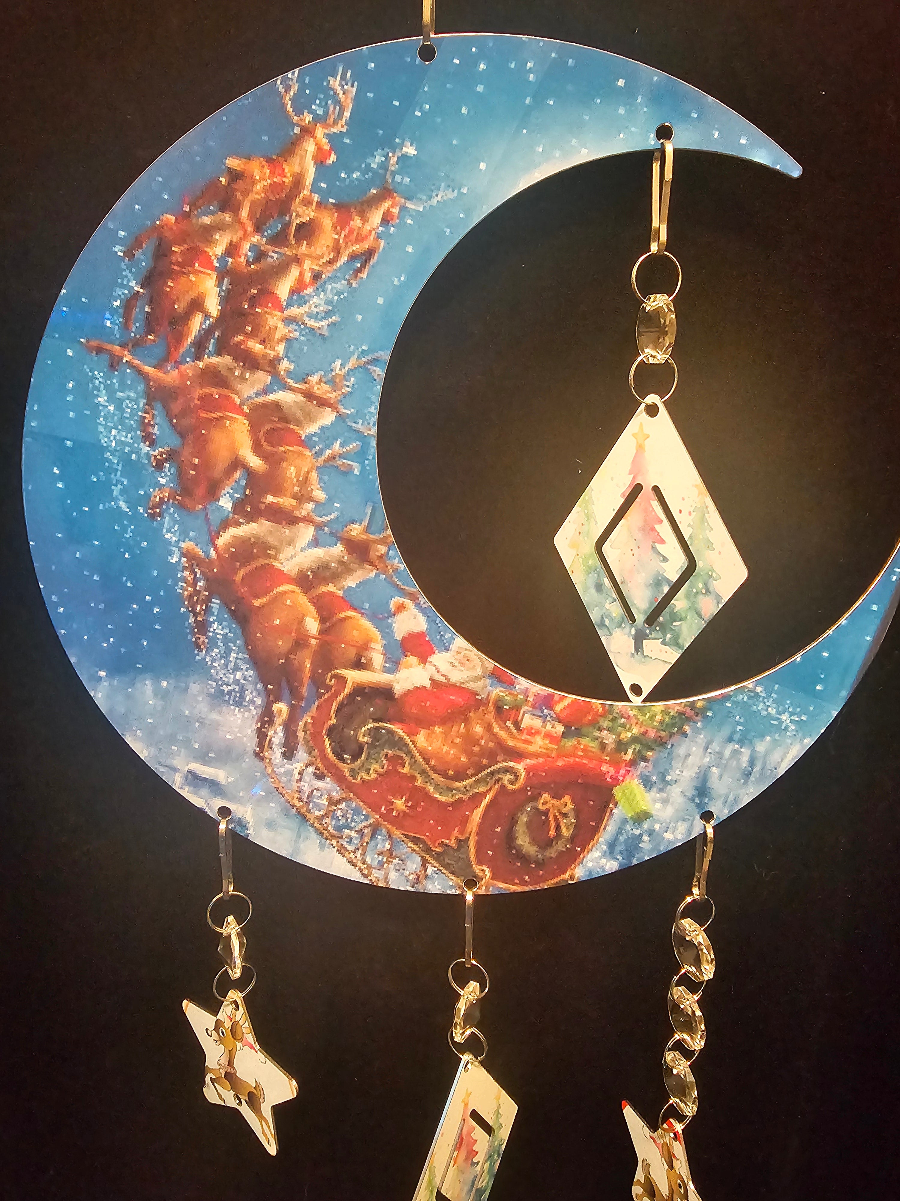 Moon Shaped Wind Spinner with the Reindeer Pulling Santa's Sleigh